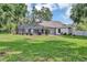 Spacious backyard featuring a screened-in patio, perfect for entertaining or enjoying peaceful evenings at 34231 Shadewood Cir, Leesburg, FL 34788