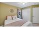 Comfortable bedroom with a ceiling fan, matching curtains, and ample closet space at 34231 Shadewood Cir, Leesburg, FL 34788