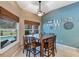 Charming dining room with large window, ceiling fan and backyard pool view at 34231 Shadewood Cir, Leesburg, FL 34788