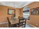Inviting dining room with wood flooring, artistic decor, and ample natural light shining through the window at 34231 Shadewood Cir, Leesburg, FL 34788