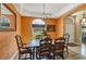 Elegant dining room featuring warm wall colors, decorative chandelier, and views of the outdoors at 34231 Shadewood Cir, Leesburg, FL 34788
