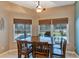 Bright dining room features a wooden table and six chairs, with view of the pool at 34231 Shadewood Cir, Leesburg, FL 34788