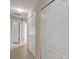 Bright hallway with tiled flooring and multiple storage closets near open doorways at 34231 Shadewood Cir, Leesburg, FL 34788