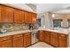 This kitchen features granite counters, stainless steel appliances, stone backsplash and wooden cabinets at 34231 Shadewood Cir, Leesburg, FL 34788