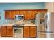 Spacious kitchen boasts stainless appliances, mosaic backsplash, and ample cabinet space at 34231 Shadewood Cir, Leesburg, FL 34788