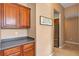 Extended kitchen area with stainless steel refrigerator, additional storage, and view of adjacent rooms at 34231 Shadewood Cir, Leesburg, FL 34788