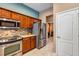Well-lit kitchen showcases stainless steel appliances and seamless access to the laundry area at 34231 Shadewood Cir, Leesburg, FL 34788