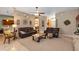 Open living area featuring leather sofas, neutral color scheme, and tile flooring at 34231 Shadewood Cir, Leesburg, FL 34788