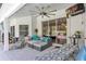 Relaxing covered patio offers comfortable seating, a ceiling fan, and a view of the pool at 34231 Shadewood Cir, Leesburg, FL 34788