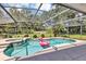 Enclosed pool area includes a refreshing pool and hot tub, surrounded by lush greenery at 34231 Shadewood Cir, Leesburg, FL 34788