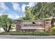 Stone Silverwood community sign with lush landscaping and a palm tree set against a blue sky at 34231 Shadewood Cir, Leesburg, FL 34788