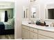 Well-lit bathroom features double vanity, modern fixtures, and an adjoining bedroom, offering comfort and style at 3466 Smedley Rd, The Villages, FL 32163