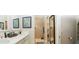 Modern bathroom with dual sinks, a walk-in shower, and neutral tile at 3466 Smedley Rd, The Villages, FL 32163