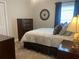 Inviting bedroom with plush carpeting, a comfy bed, and a stylish dresser for relaxing at 3466 Smedley Rd, The Villages, FL 32163