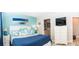 Coastal bedroom with blue accents, white furniture, and a flat-screen TV at 3466 Smedley Rd, The Villages, FL 32163