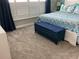Cozy bedroom featuring plush carpeting, window with plantation shutters, and stylish furnishings at 3466 Smedley Rd, The Villages, FL 32163