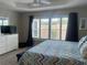 Cozy bedroom with shuttered windows, dresser, and soft carpet, perfect for relaxation at 3466 Smedley Rd, The Villages, FL 32163