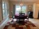 Cozy dining area with a round table, elegant chandelier, and sliding glass doors to the outside at 3466 Smedley Rd, The Villages, FL 32163