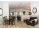 Elegant dining area with hardwood floors, a glass-top table, and an open concept to the kitchen at 3466 Smedley Rd, The Villages, FL 32163