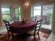 The dining area features a round table with a beautiful chandelier and sliding doors to the patio at 3466 Smedley Rd, The Villages, FL 32163