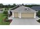 Attractive home featuring a two-car garage, landscaped yard, and neutral tones at 3466 Smedley Rd, The Villages, FL 32163