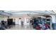 Spacious garage with ample storage, a golf cart, and a door to the interior at 3466 Smedley Rd, The Villages, FL 32163