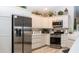 Modern kitchen features stainless steel appliances, white cabinets and granite countertops at 3466 Smedley Rd, The Villages, FL 32163