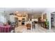 Open-concept kitchen with stainless steel appliances, white cabinetry, and a breakfast bar that integrates into the living space at 3466 Smedley Rd, The Villages, FL 32163