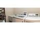 Well-equipped laundry room featuring a utility sink, washer, and dryer at 3466 Smedley Rd, The Villages, FL 32163