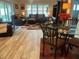 Comfortable living room and dining area featuring wood floors, leather seating, and views to outside at 3466 Smedley Rd, The Villages, FL 32163