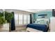 Relaxing bedroom features a comfortable bed, plantation shutters, and a decorative plant, creating a serene and inviting space at 3466 Smedley Rd, The Villages, FL 32163