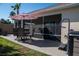 A patio with seating area and hot tub provides a relaxing outdoor space for homeowners at 3466 Smedley Rd, The Villages, FL 32163