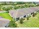 Aerial view of home with lush backyard and enclosed screen porch at 3547 Fairwaters Ct # F, Clermont, FL 34711