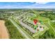 Aerial view of a community with a marker indicating the property location and green space nearby at 3547 Fairwaters Ct # F, Clermont, FL 34711
