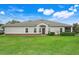 This backyard features a well-manicured lawn and neatly trimmed hedges surrounding the house at 3547 Fairwaters Ct # F, Clermont, FL 34711