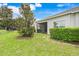 Beautiful backyard featuring lush green grass, manicured hedges and view of screened lanai at 3547 Fairwaters Ct # F, Clermont, FL 34711