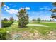 Expansive green backyard featuring a small sand trap area, beautiful for outdoor enjoyment at 3547 Fairwaters Ct # F, Clermont, FL 34711