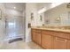 Bathroom features double sinks, granite countertops, and glass shower at 3547 Fairwaters Ct # F, Clermont, FL 34711