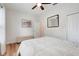 Cozy bedroom with ceiling fan, light hardwood floors, and picture in the background at 3547 Fairwaters Ct # F, Clermont, FL 34711