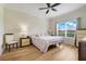 A bedroom featuring a neutral color scheme and window view at 3547 Fairwaters Ct # F, Clermont, FL 34711