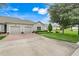 Inviting home features a two-car garage and pristine landscaping enhancing curb appeal at 3547 Fairwaters Ct # F, Clermont, FL 34711