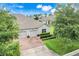 Aerial view of home exterior with driveway and well-manicured landscaping at 3547 Fairwaters Ct # F, Clermont, FL 34711