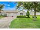 Charming home features a two-car garage, well-manicured lawn, and neat shrubbery at 3547 Fairwaters Ct # F, Clermont, FL 34711