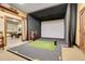 Indoor golf simulator room with padded walls and artificial turf at 3547 Fairwaters Ct # F, Clermont, FL 34711