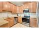 This kitchen boasts stainless steel appliances, granite countertops and wooden cabinetry at 3547 Fairwaters Ct # F, Clermont, FL 34711