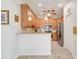 Bright kitchen features wooden cabinets, stainless steel appliances, and granite countertops at 3547 Fairwaters Ct # F, Clermont, FL 34711