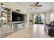 Open living room with tile flooring and sliding glass doors to backyard at 3547 Fairwaters Ct # F, Clermont, FL 34711