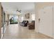 Bright and open living room featuring tile floors, comfortable seating, and backyard views at 3547 Fairwaters Ct # F, Clermont, FL 34711