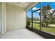 Screened porch with ceiling fan and view of the backyard at 3547 Fairwaters Ct # F, Clermont, FL 34711