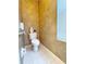 Bathroom with a toilet, window with blinds, and patterned wallpaper at 3555 Chapel Hill Blvd, Clermont, FL 34711